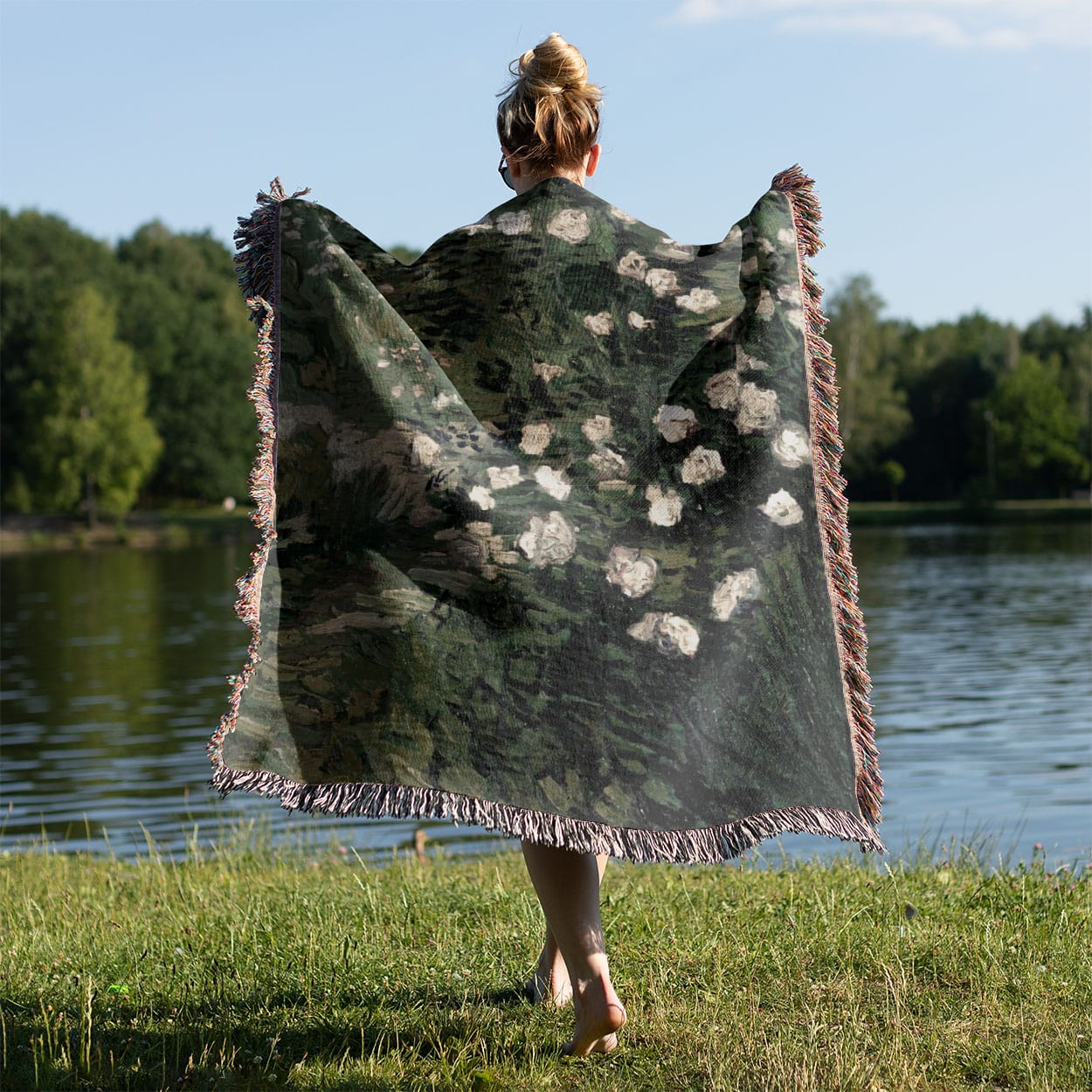 Green with White Flowers Woven Throw Blanket Held on a Woman's Back Outside