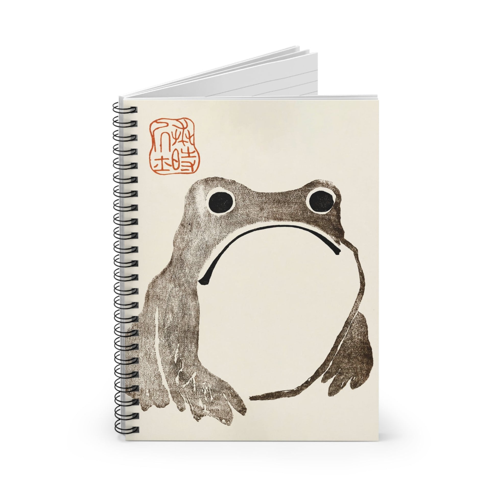 Grumpy Frog Spiral Notebook Standing up on White Desk