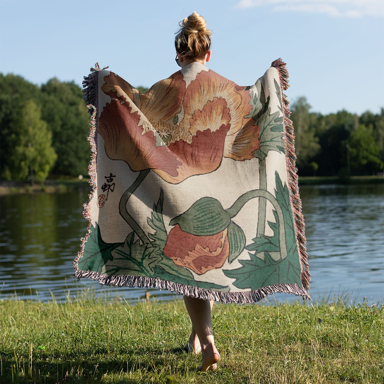 Japanese Orange Flower Woven Throw Blanket Held on a Woman's Back Outside