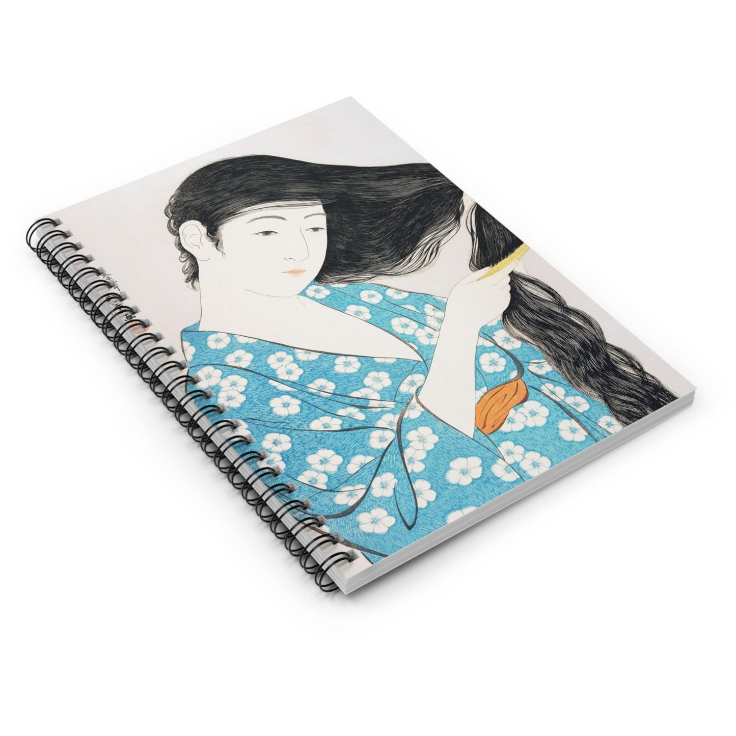 Japanese Spiral Notebook Laying Flat on White Surface