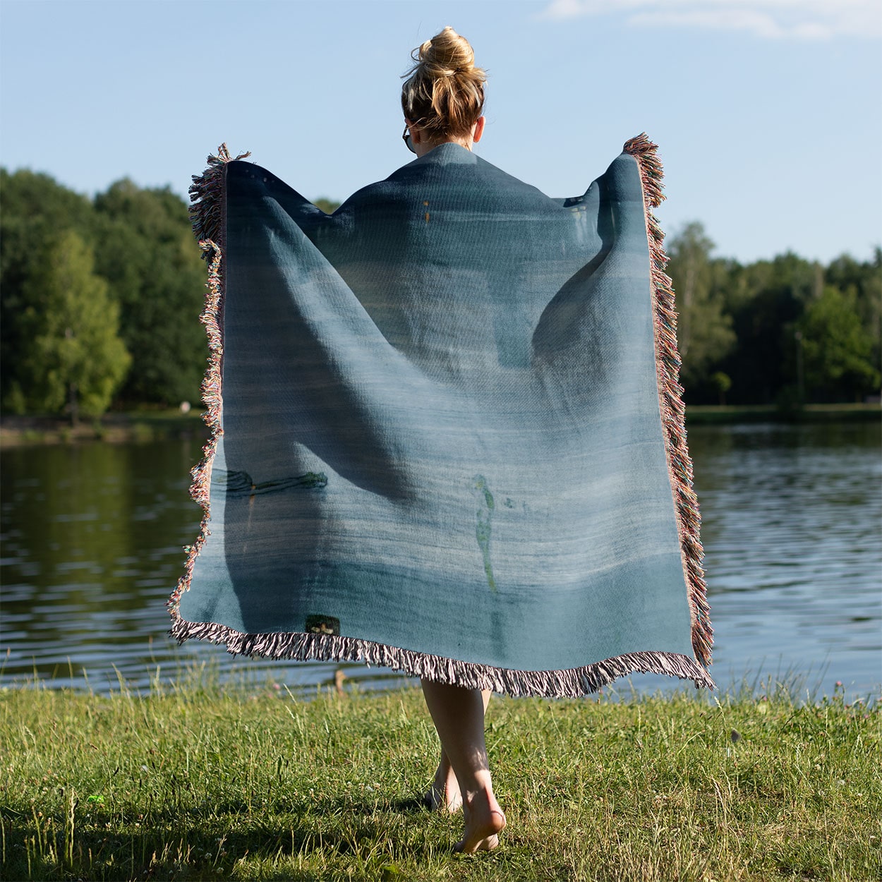 Light Blue Abstract Woven Blanket Held Up Outside