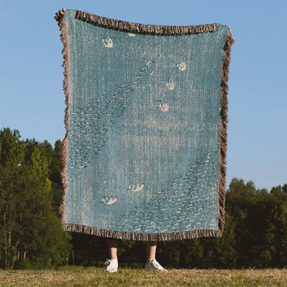 Light Blue Minimalist Woven Blanket Held on a Woman's Back Outside