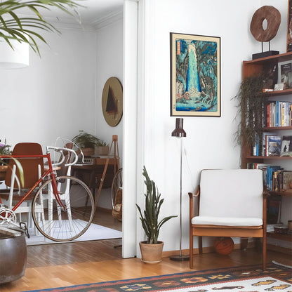 Eclectic living room with a road bike, bookshelf and house plants that features framed artwork of a Surreal Water Landscape above a chair and lamp