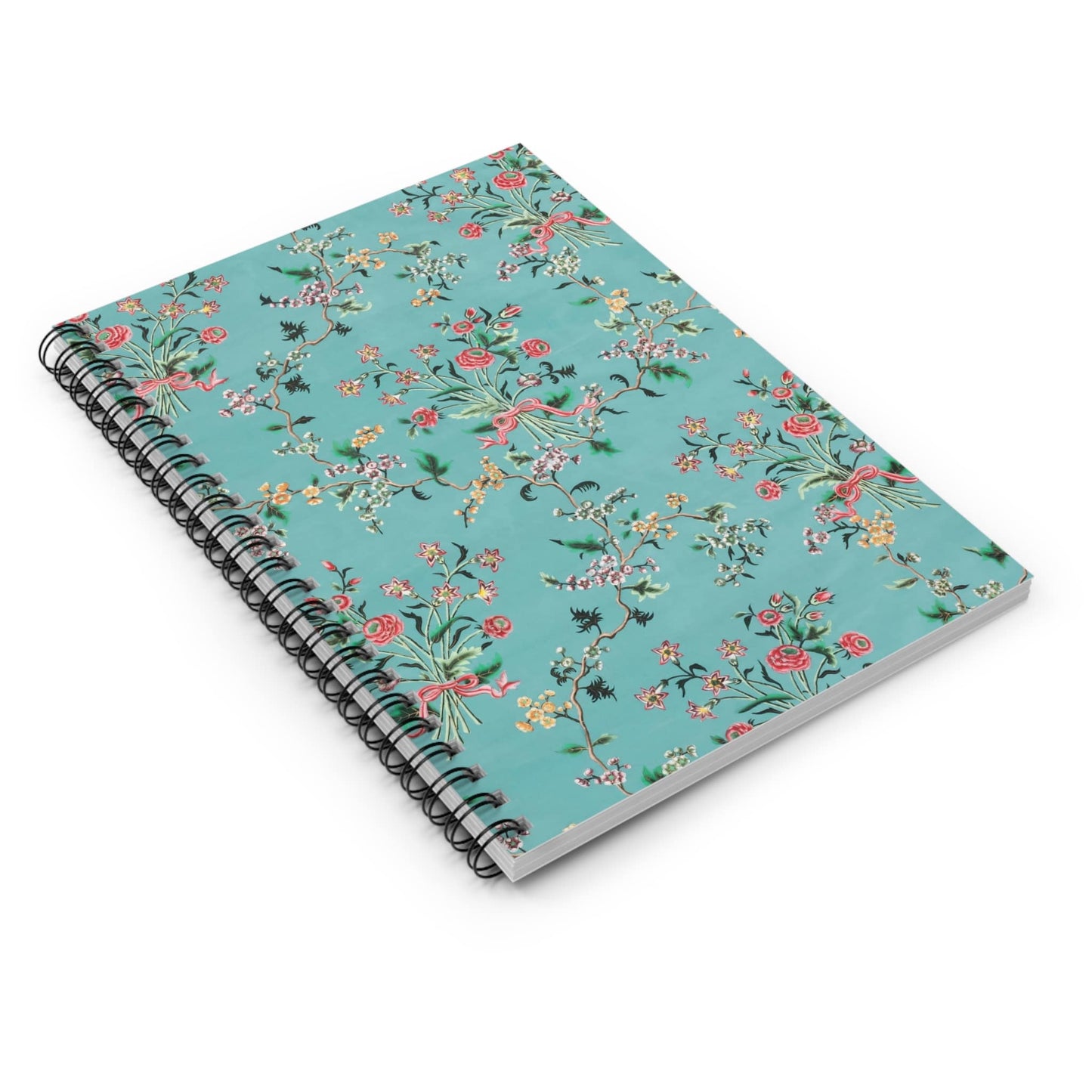 Light Floral Spiral Notebook Laying Flat on White Surface