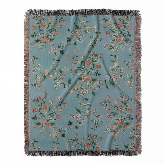 Light Floral woven throw blanket, made of 100% cotton, featuring a soft and cozy texture with light blue and pink designs for home decor.