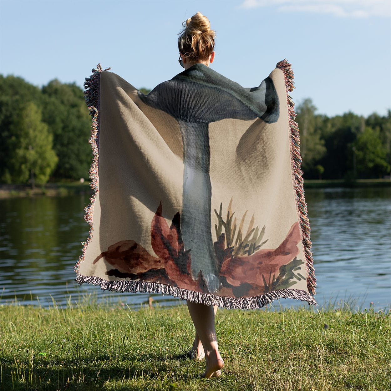 Little Blue Mushrooms Woven Throw Blanket Held on a Woman's Back Outside