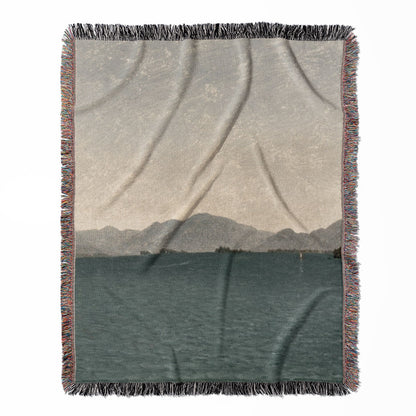 Minimalist Mountains woven throw blanket, made with 100% cotton, featuring a soft and cozy texture with a lake painting for home decor.