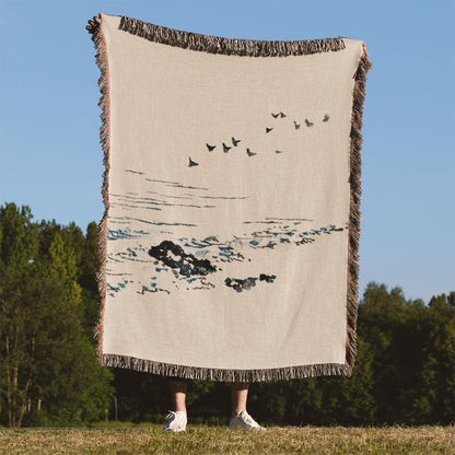 Minimalist Ocean Woven Blanket Held on a Woman's Back Outside