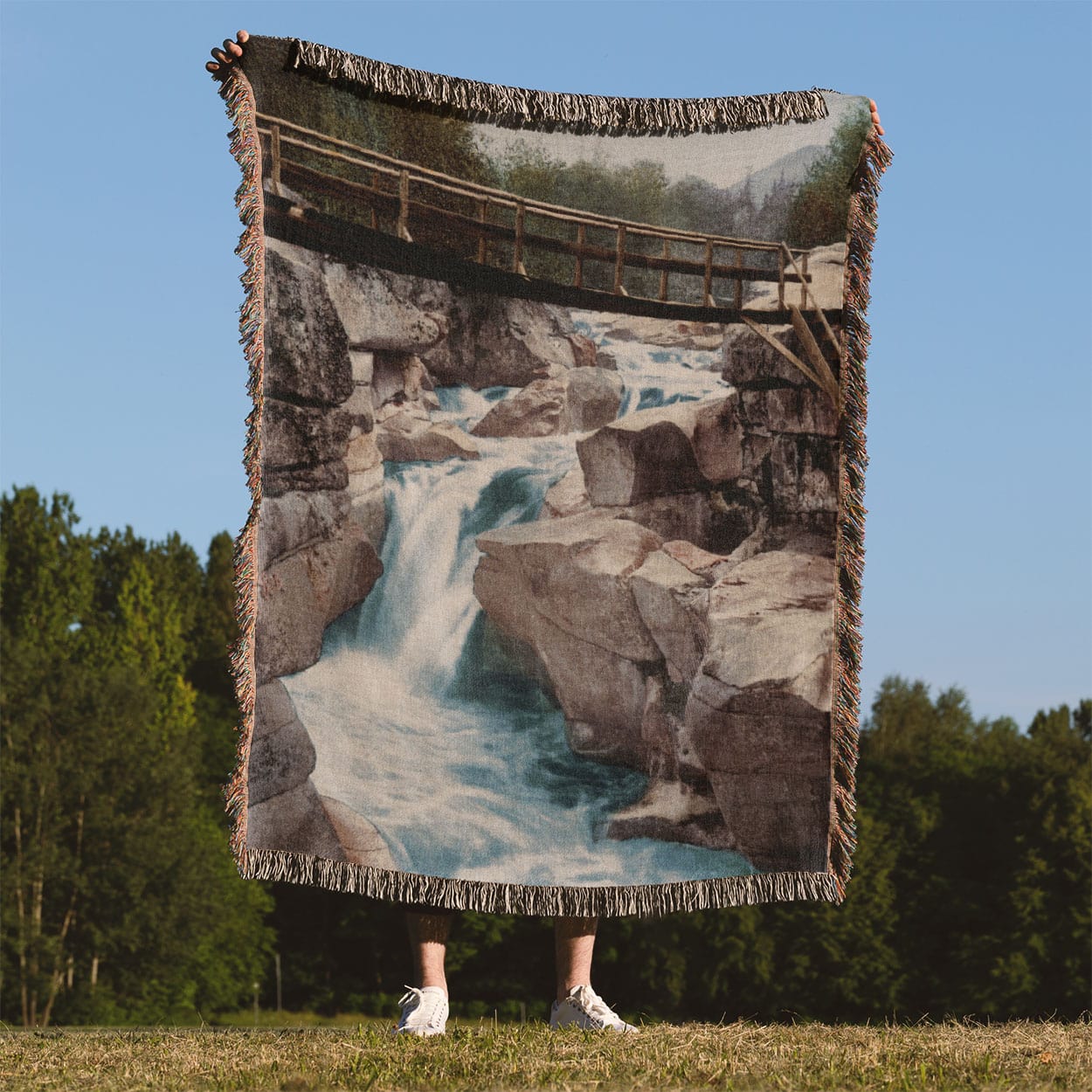 Mountain River Woven Blanket Held on a Woman's Back Outside