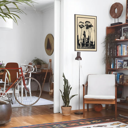 Eclectic living room with a road bike, bookshelf and house plants that features framed artwork of a Mushroom Garden above a chair and lamp