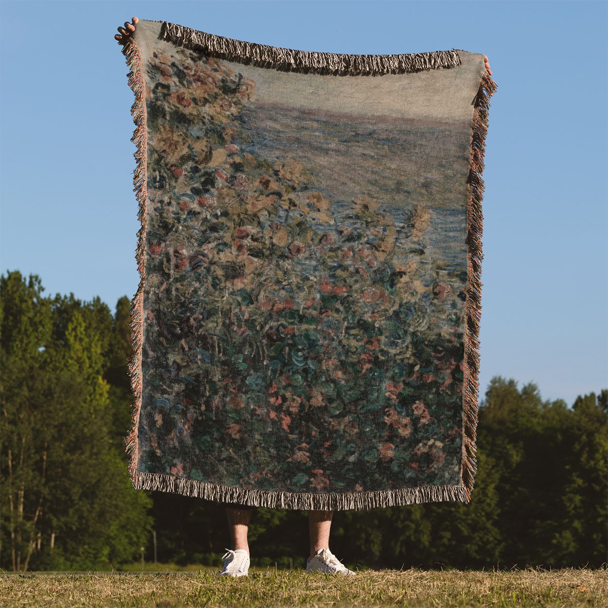 Muted Floral Woven Blanket Held on a Woman's Back Outside