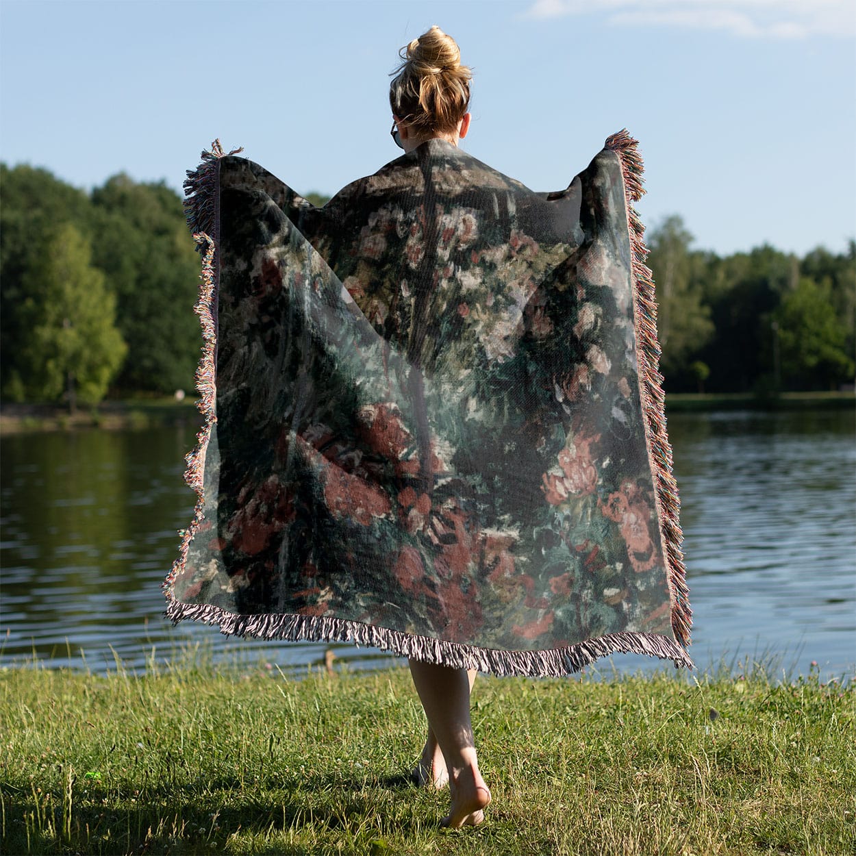 Muted Flowers Woven Throw Blanket Held on a Woman's Back Outside