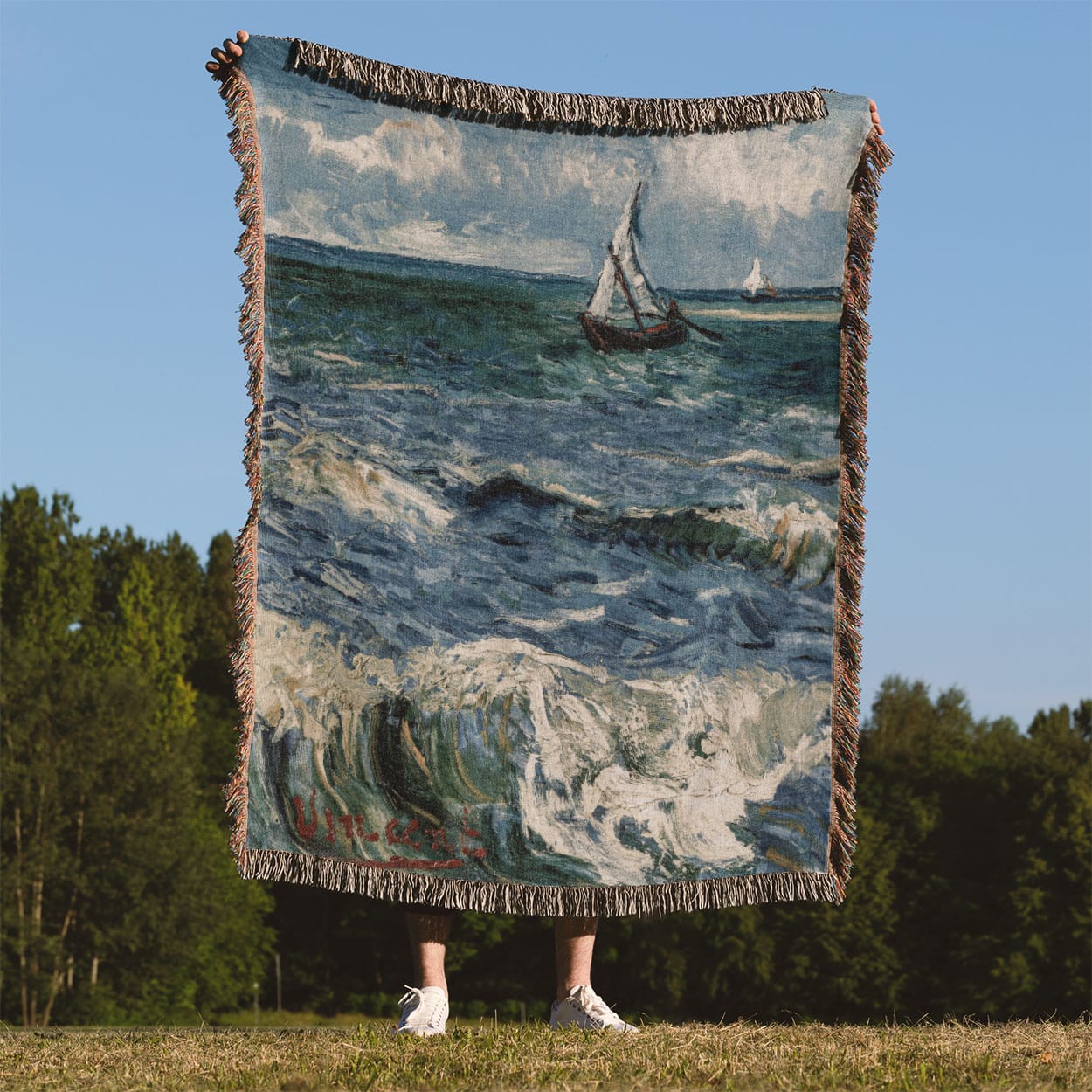 Ocean Woven Blanket Held on a Woman's Back Outside