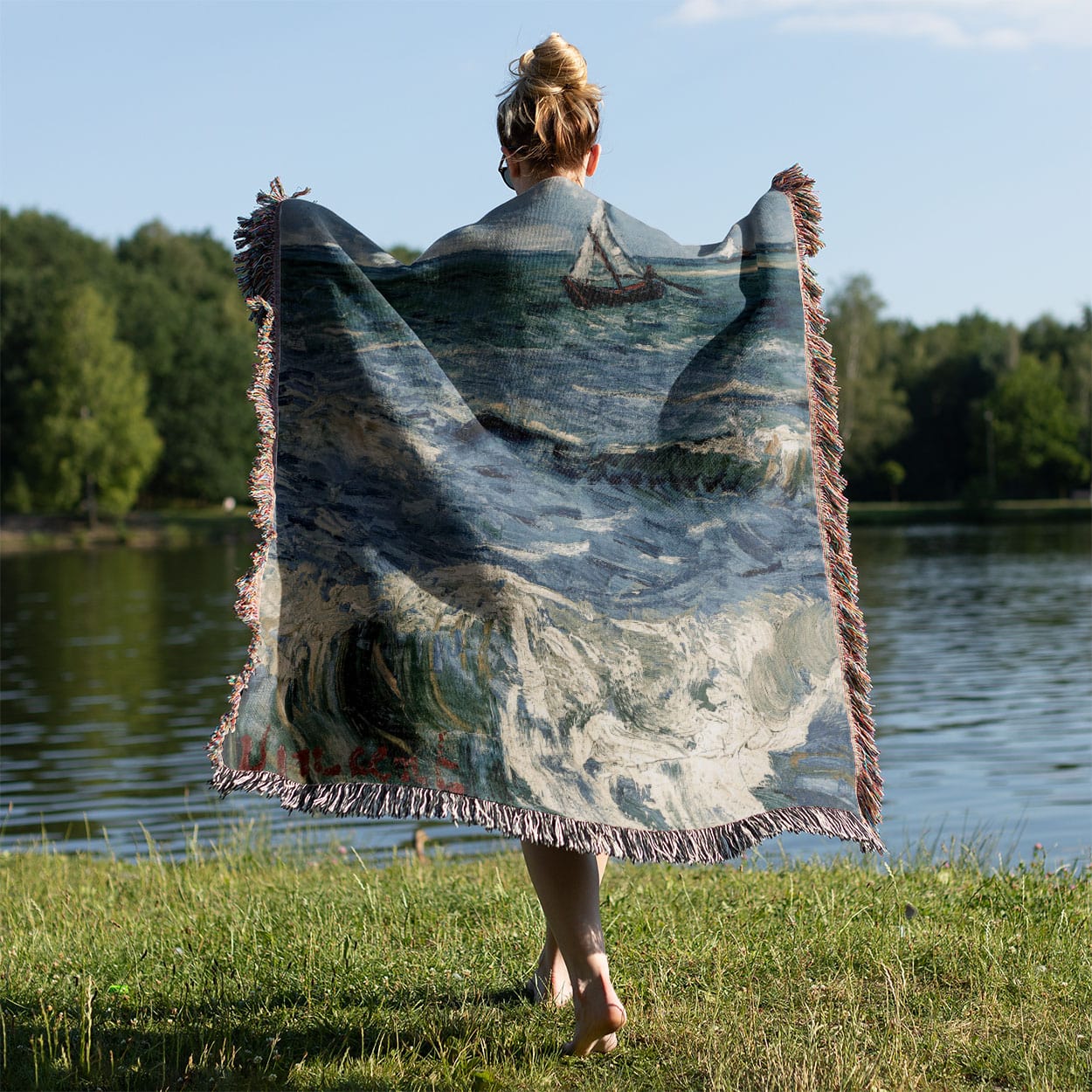 Ocean Woven Throw Blanket Held on a Woman's Back Outside