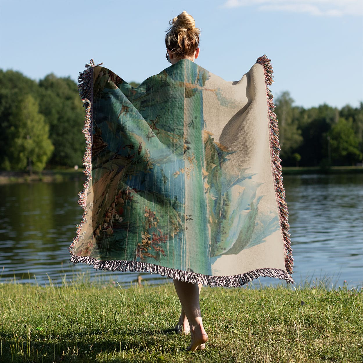 Ocean Woven Throw Blanket Held on a Woman's Back Outside