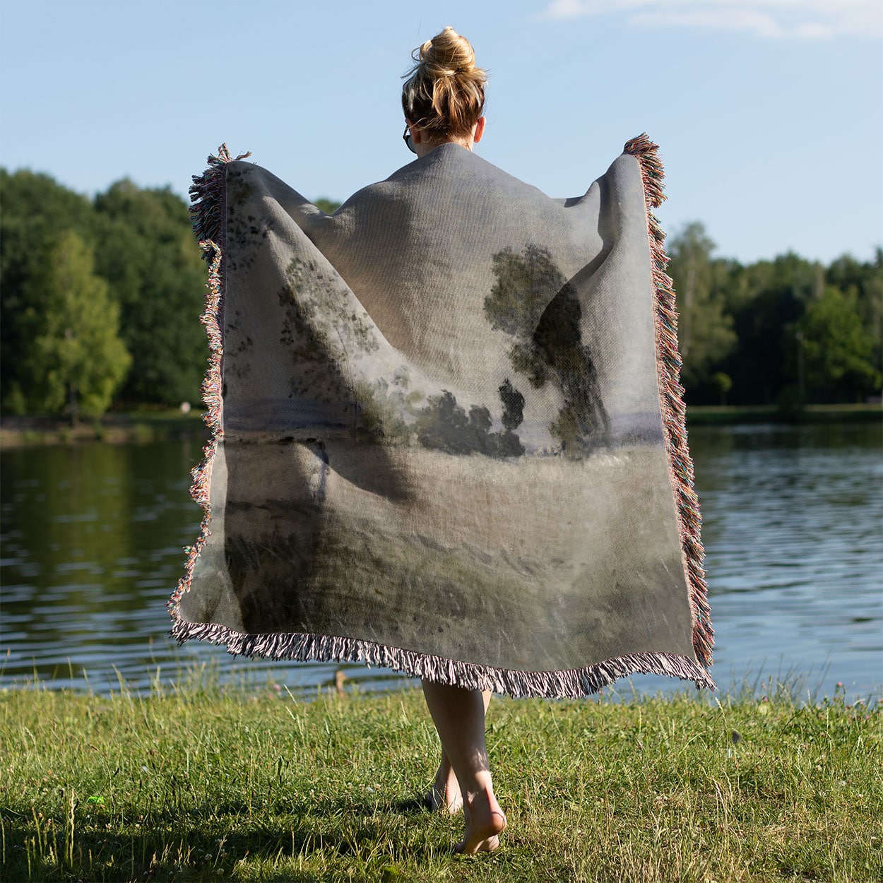 Old-Timey Get Away Woven Throw Blanket Held on a Woman's Back Outside