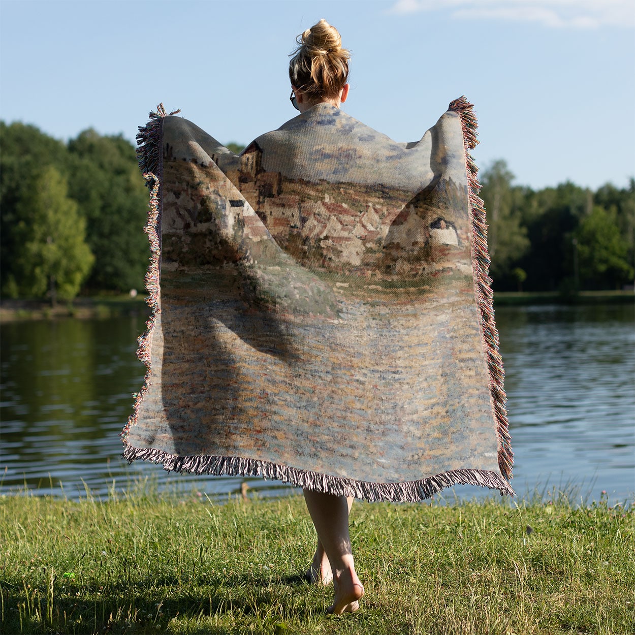 Paris Landscape Woven Throw Blanket Held on a Woman's Back Outside