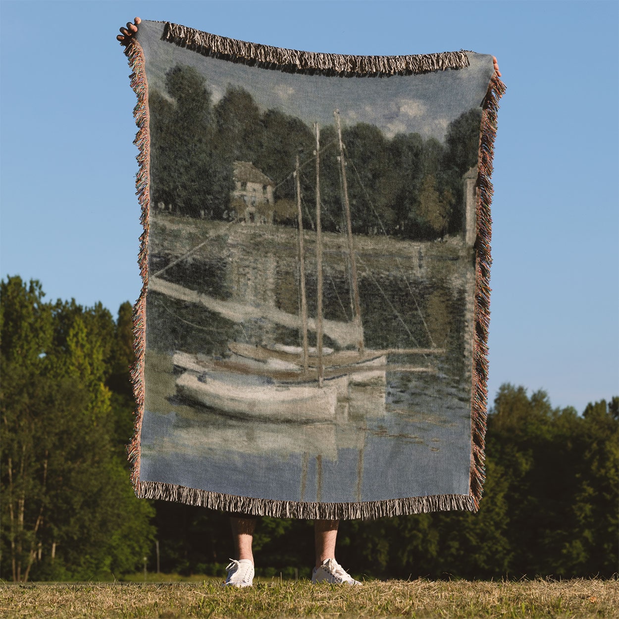 Peaceful River Woven Blanket Held on a Woman's Back Outside