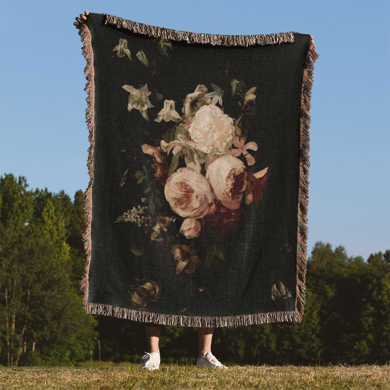 Peony Woven Blanket Held on a Woman's Back Outside