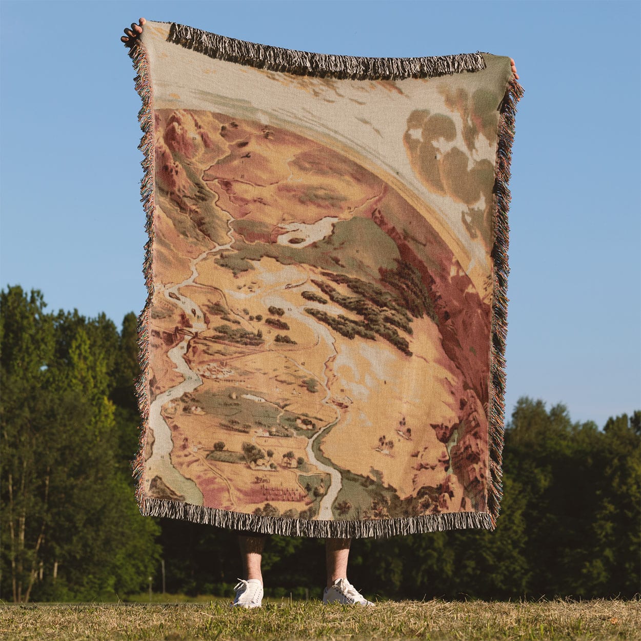 Pictorial of Earth Woven Blanket Held on a Woman's Back Outside