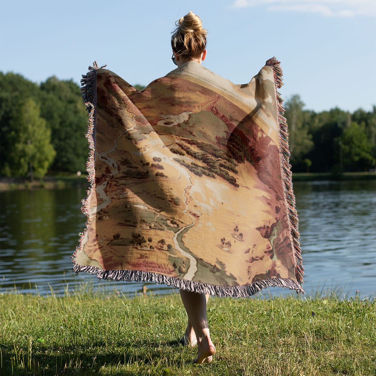 Pictorial of Earth Woven Throw Blanket Held on a Woman's Back Outside