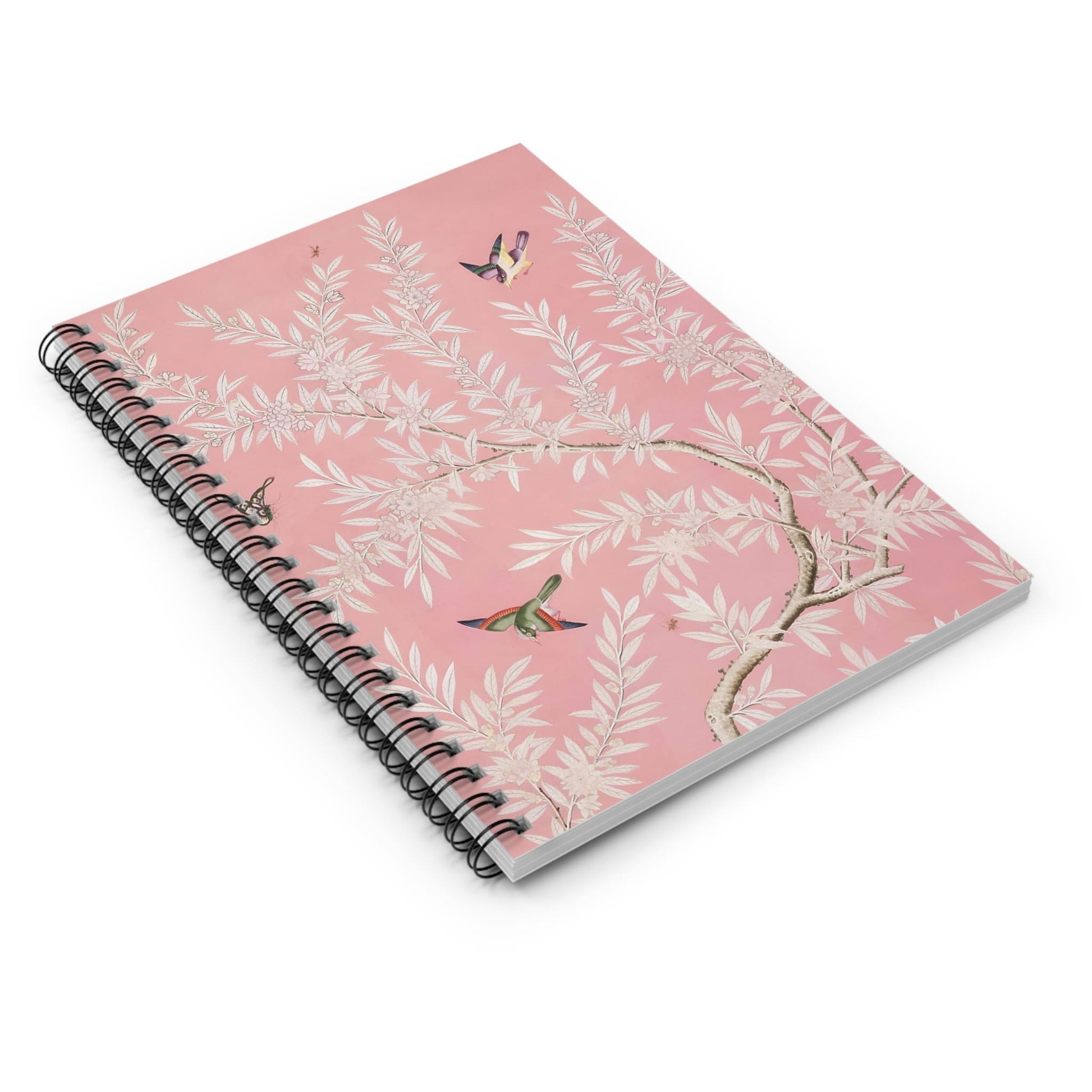 Pink Floral Spiral Notebook Laying Flat on White Surface
