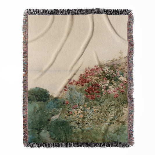 Poppy woven throw blanket, crafted from 100% cotton, offering a soft and cozy texture with a landscape painting design for home decor.