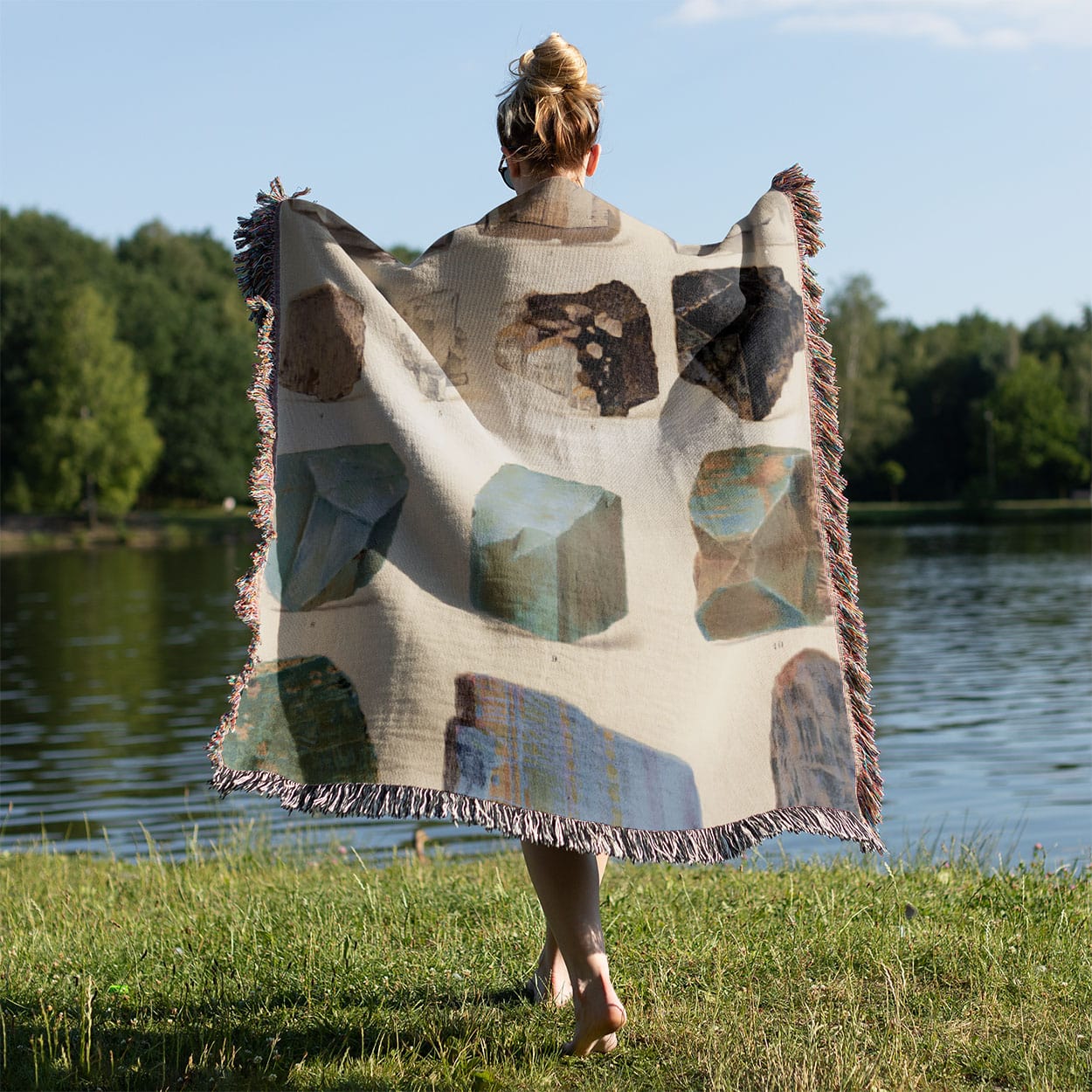 Raw Crystals and Gemstones Woven Blanket Held on a Woman's Back Outside