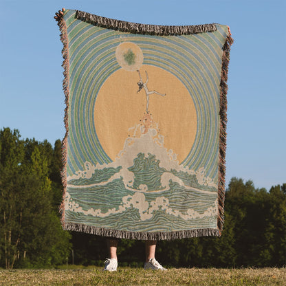 Reach for the Moon Woven Blanket Held Up Outside