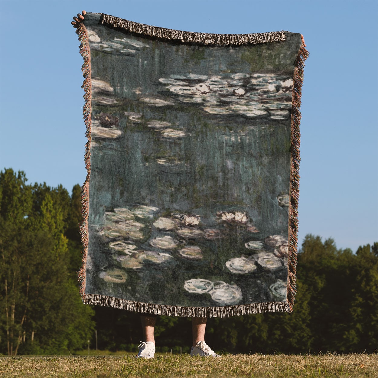 Relaxing Water Painting Woven Blanket Held Up Outside