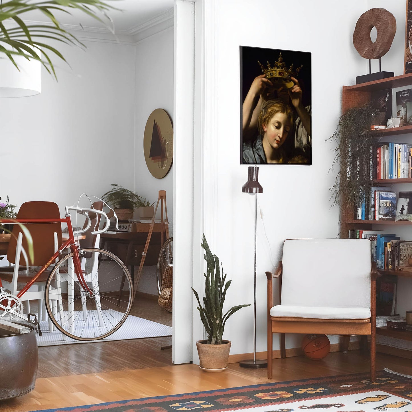 Eclectic living room with a road bike, bookshelf and house plants that features framed artwork of a Aesthetic Moody above a chair and lamp