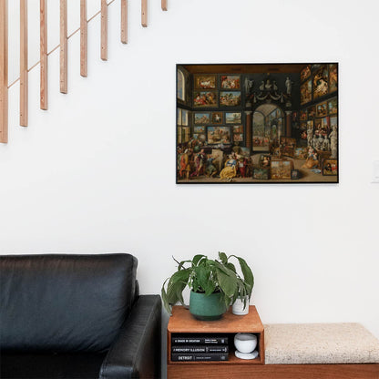 Living space with a black leather couch and table with a plant and books below a staircase featuring a framed picture of Academia and Art
