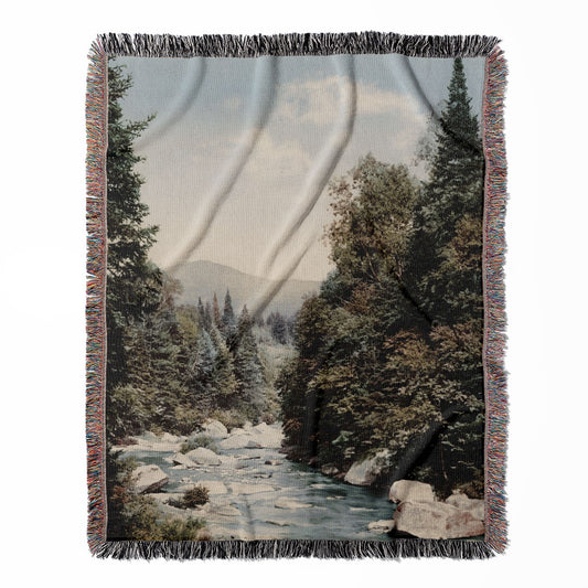 River woven throw blanket, made of 100% cotton, featuring a soft and cozy texture with peaceful mountains for home decor.