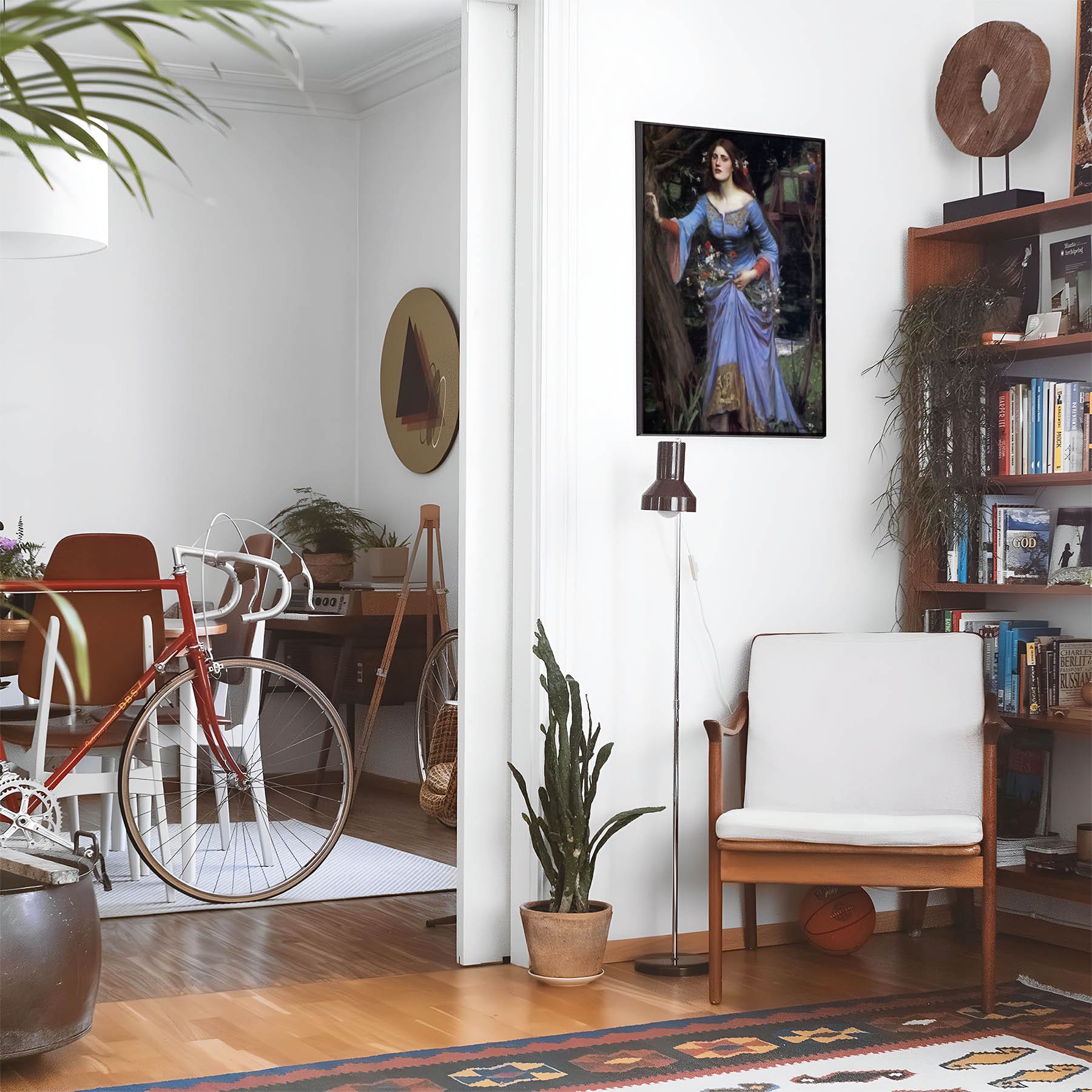 Eclectic living room with a road bike, bookshelf and house plants that features framed artwork of a Woman in a Blue Dress above a chair and lamp