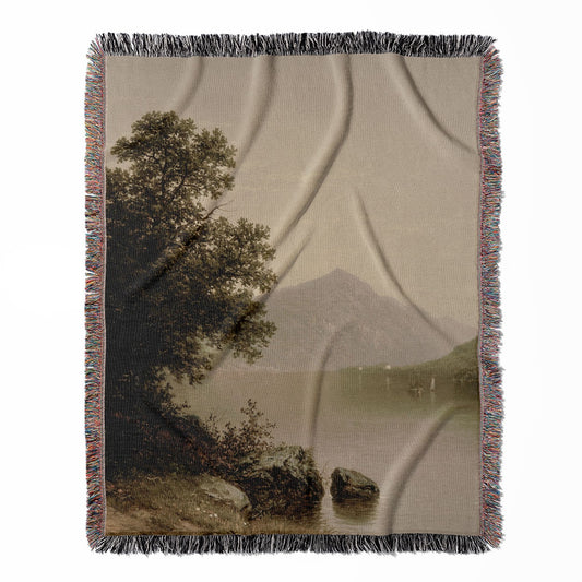 Lake George woven throw blanket, crafted from 100% cotton, offering a soft and cozy texture with a sage green painting for home decor.