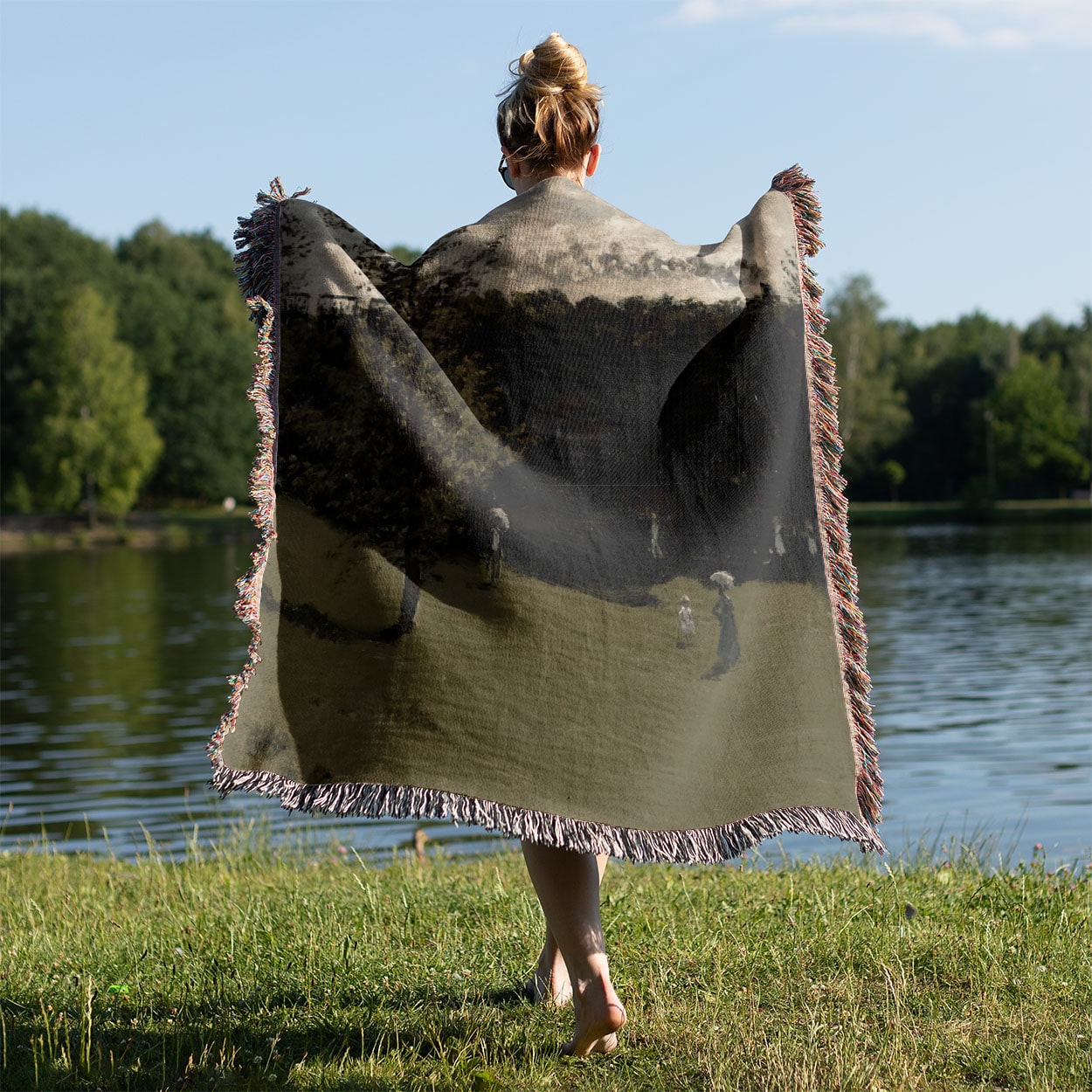 Sage Green Landscape Woven Throw Blanket Held on a Woman's Back Outside