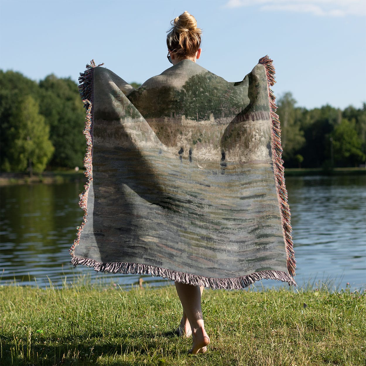 Sage Green Paris Woven Blanket Held on a Woman's Back Outside