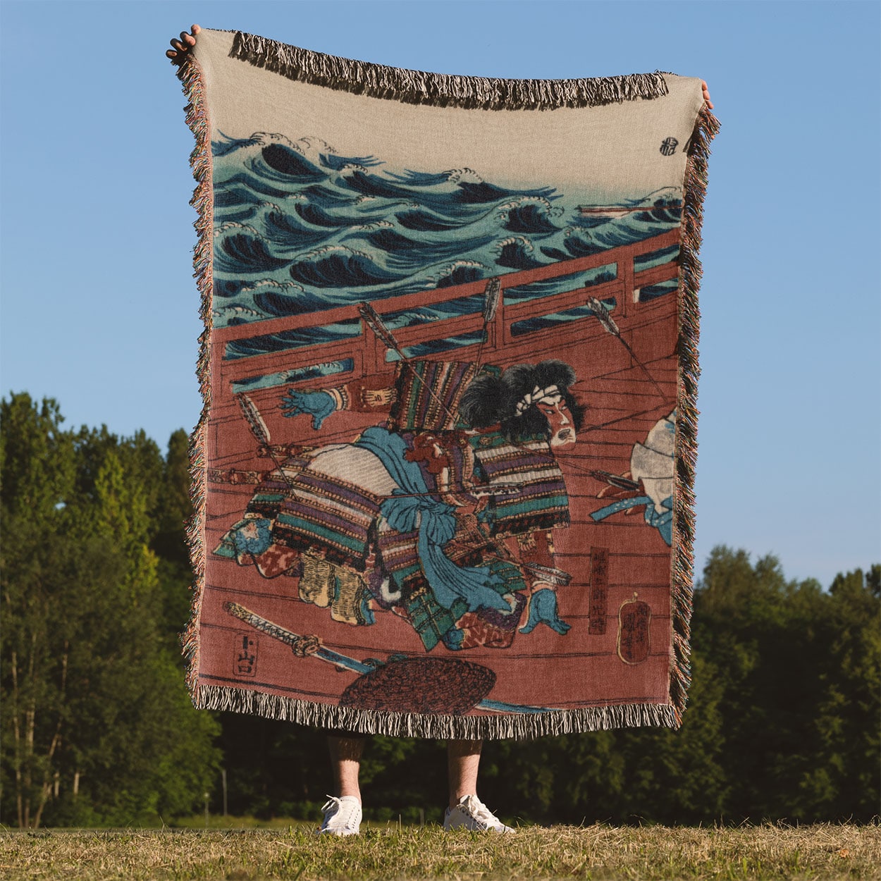 Warrior on a Boat Woven Blanket Held Up Outside