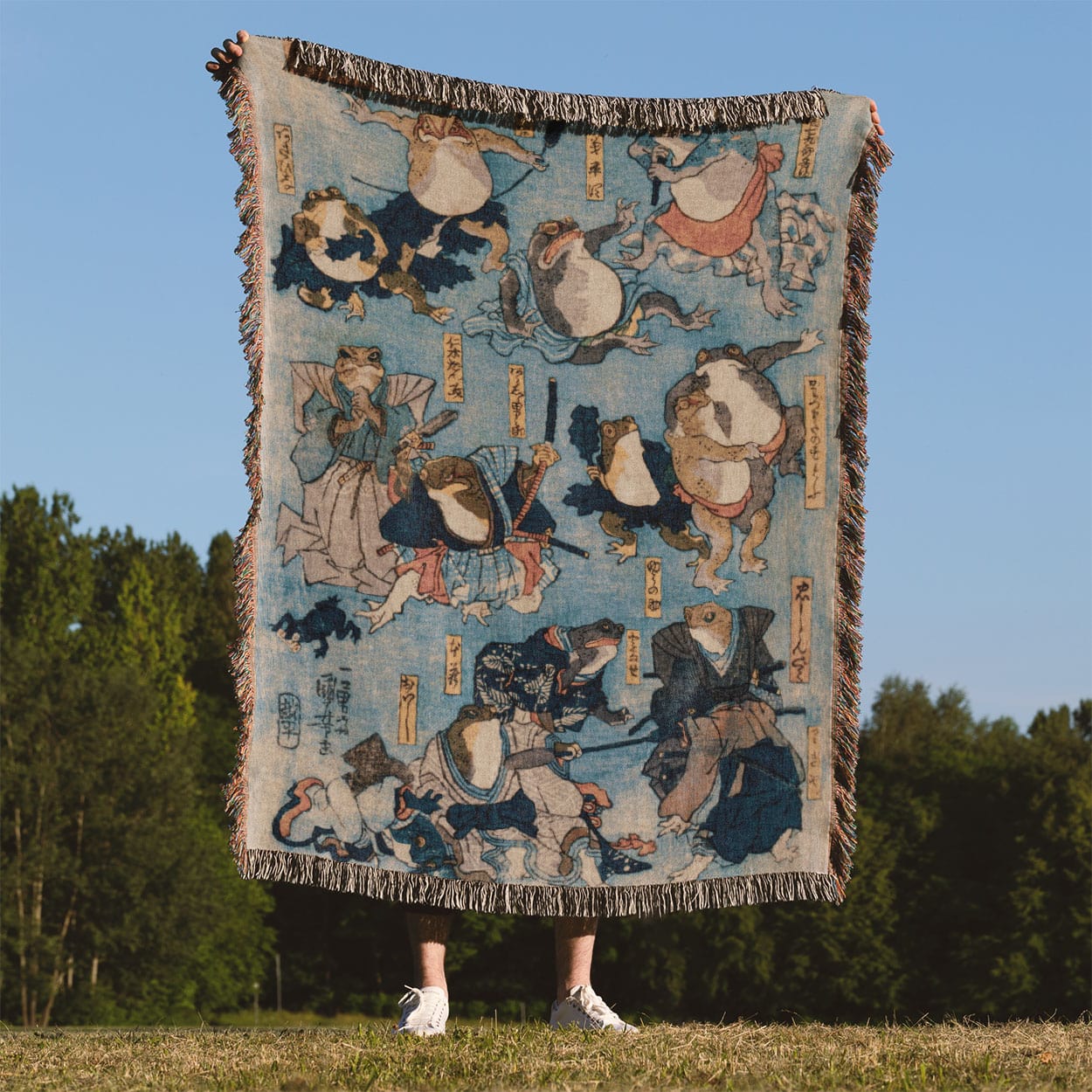 Samurai Frogs Woven Blanket Held Up Outside