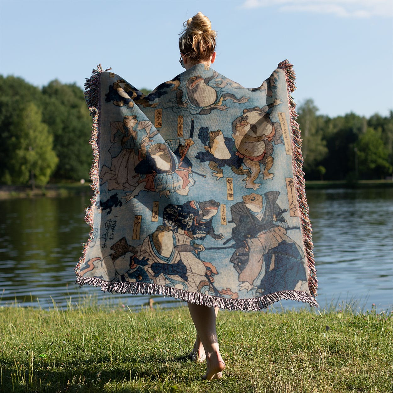 Samurai Frogs Woven Blanket Held on a Woman's Back Outside