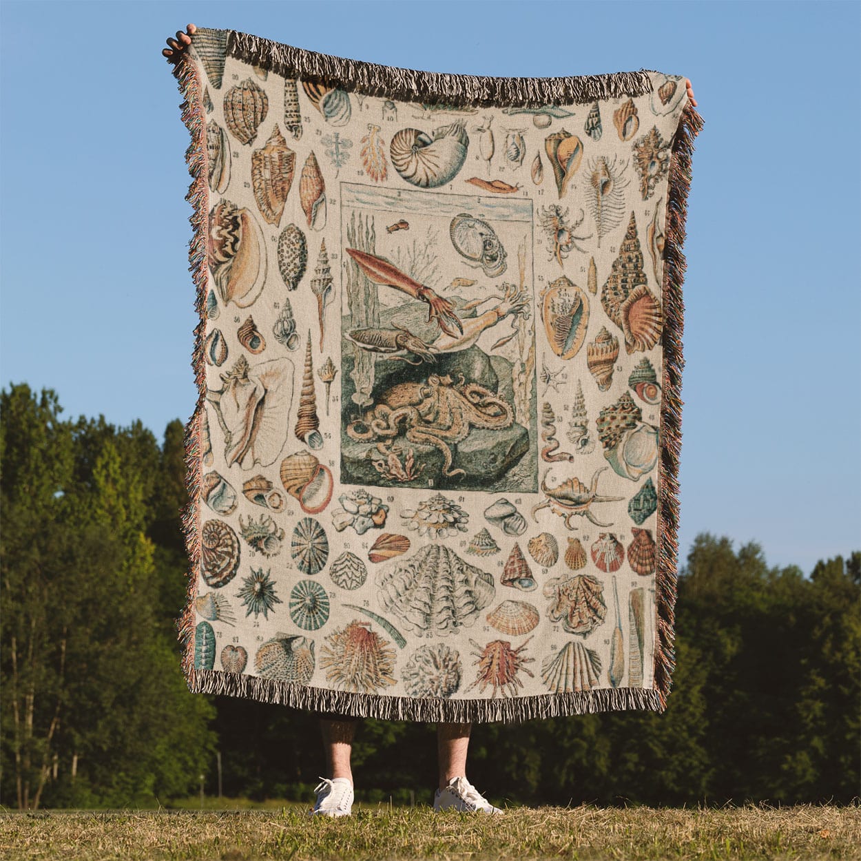 Seashells Woven Blanket Held Up Outside