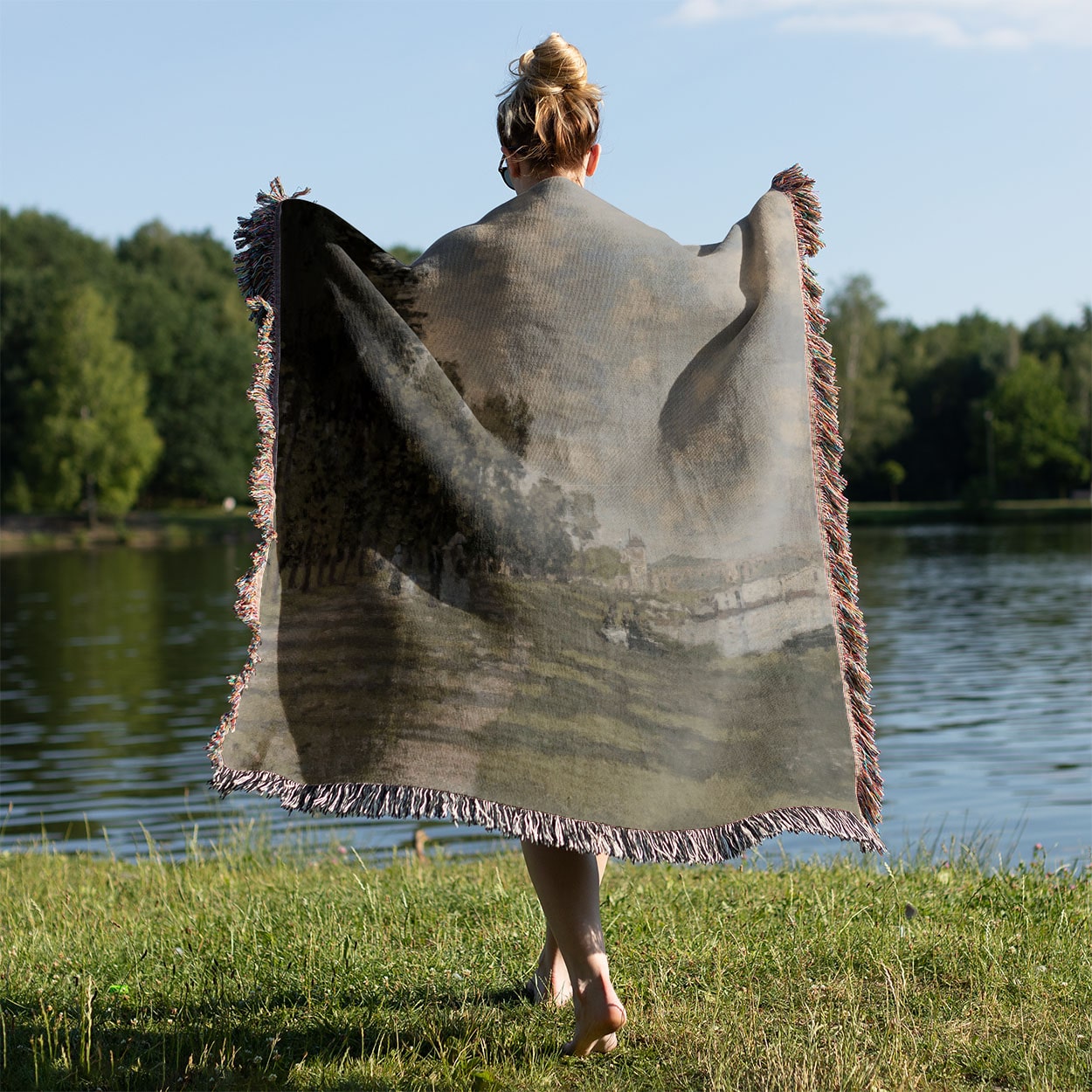 Seaside Woven Throw Blanket Held on a Woman's Back Outside