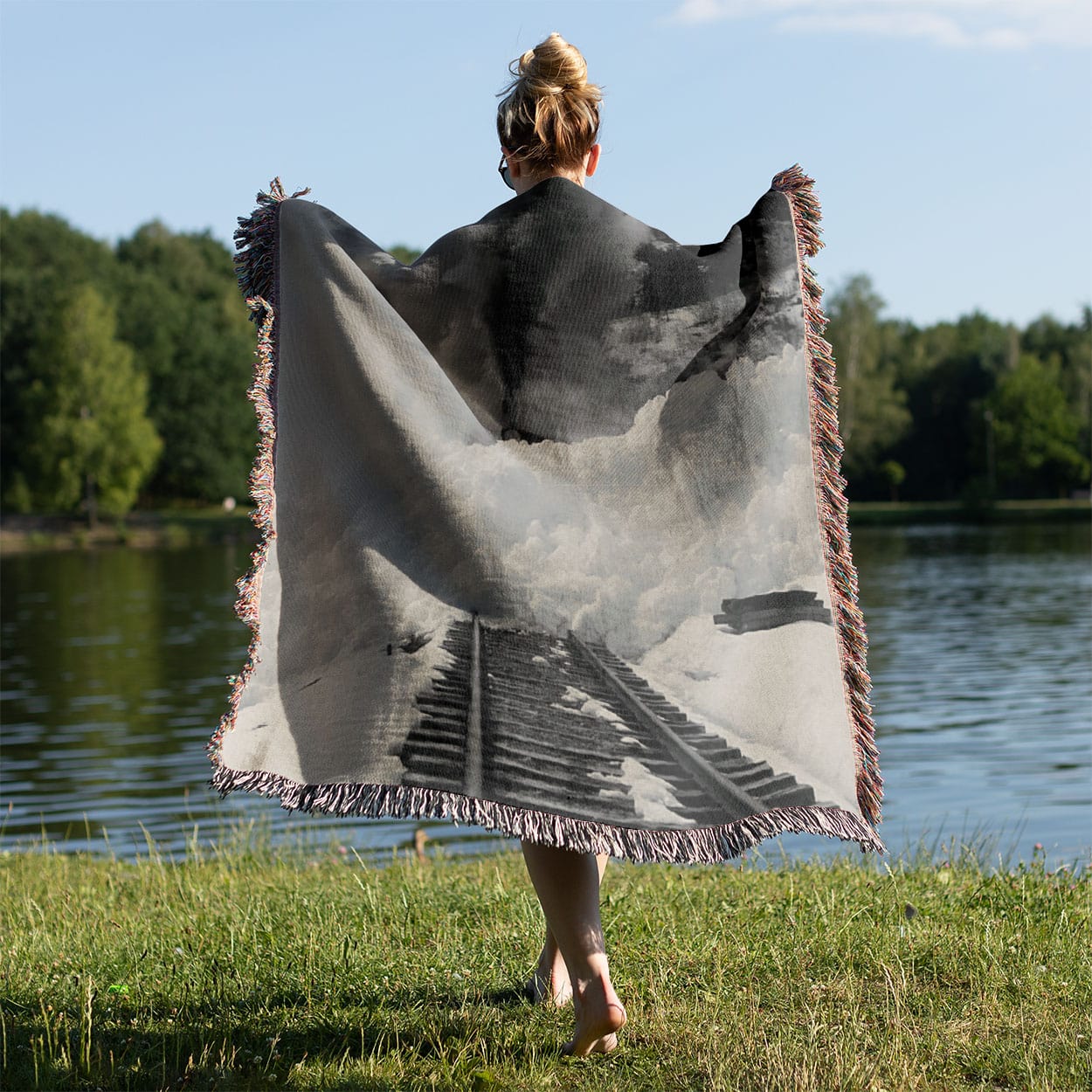 Snow Train Woven Blanket Held on a Woman's Back Outside