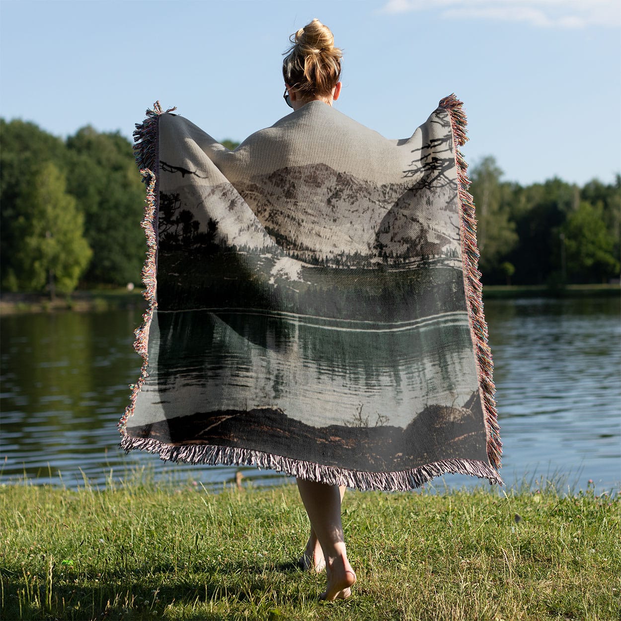 Snowy Mountains Woven Blanket Held on a Woman's Back Outside