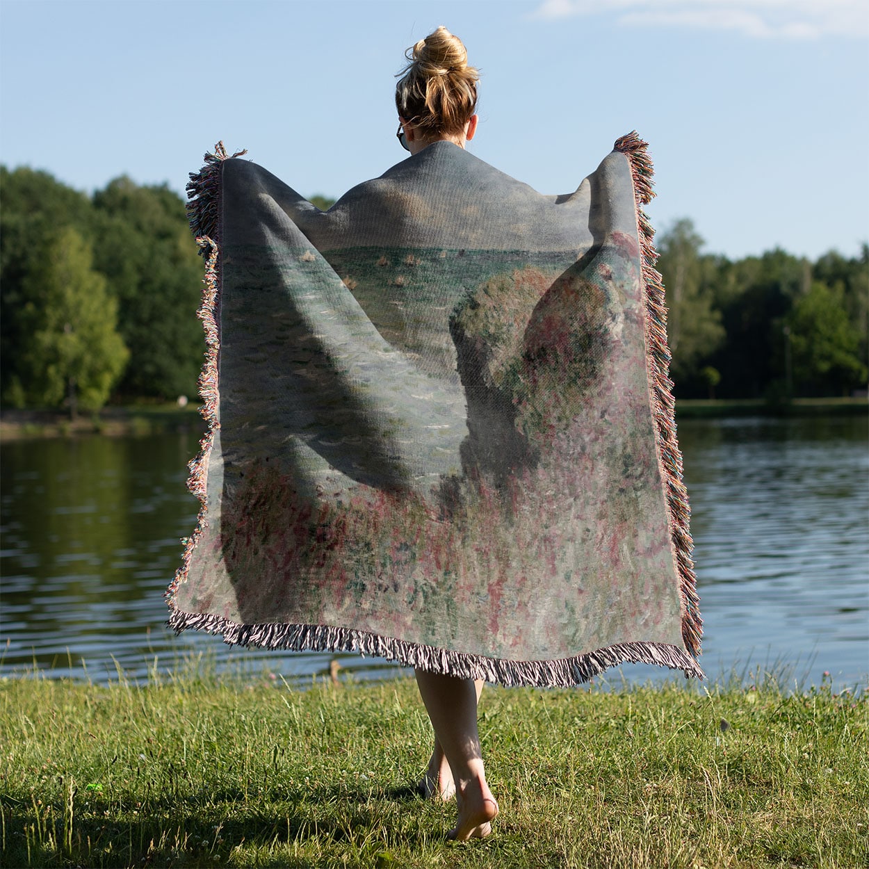 Summer Seascape Woven Blanket Held on a Woman's Back Outside
