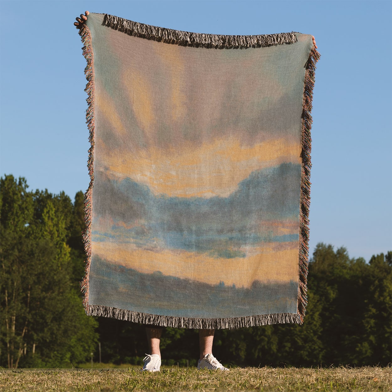 Sun in the Clouds Woven Throw Blanket Held Up Outside