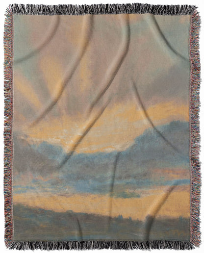 Sun in the Clouds woven throw blanket, crafted from 100% cotton, providing a soft and cozy texture with a yellow and blue design for home decor.