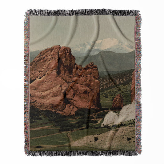 The Gateway woven throw blanket, constructed from 100% cotton, offering a soft and cozy texture with a garden of the gods theme for home decor.