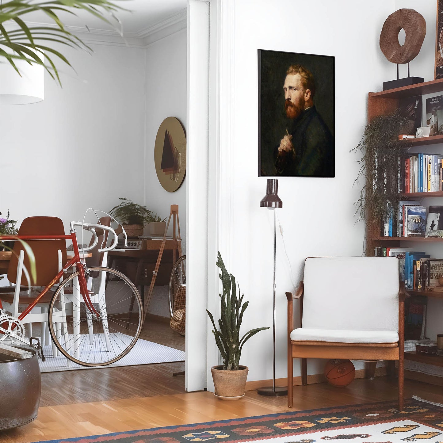 Eclectic living room with a road bike, bookshelf and house plants that features framed artwork of a Academia above a chair and lamp