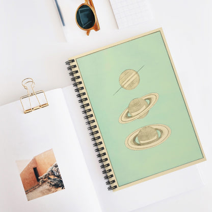 The Rings of Saturn Spiral Notebook Displayed on Desk